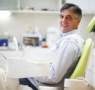 Senior man sitting in dental chair waiting for treatment